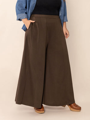 Dark brown sculpted flare palazzo trousers with pockets and a high waist.