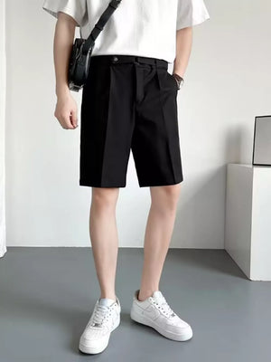 Men's black belted chino shorts with pleats and a relaxed fit.