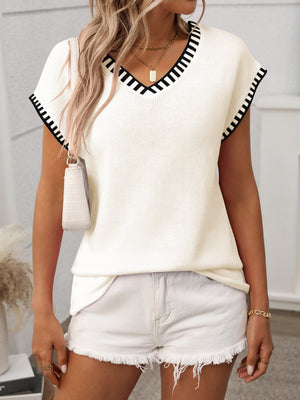 Cream knit v-neck sweater top with black contrast trim on neckline and sleeves