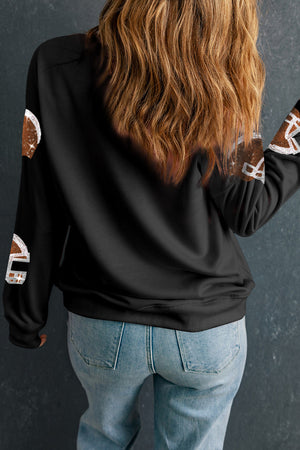 Black crewneck sweatshirt with sequin football helmet print on sleeves.