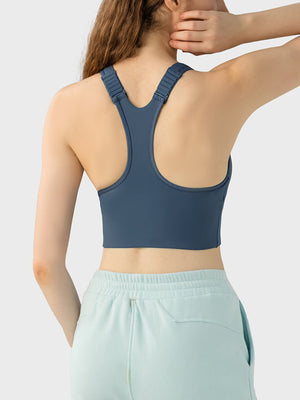 Dark blue zip-front racerback sports bra with adjustable straps.