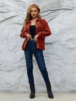 Textured corduroy button-up jacket in amber with chest pockets and button cuffs.