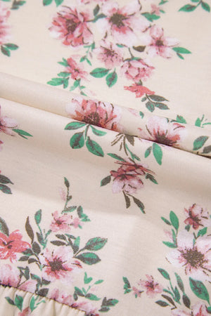 Floral print peplum blouse with square neck in floral pattern on a light background.