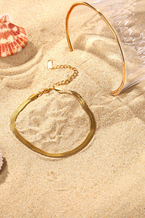 Gold herringbone chain bracelet with adjustable clasp detail.