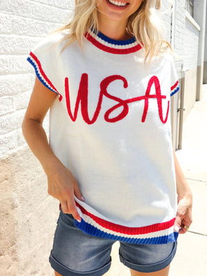 White knit sweater vest with red USA embroidery and patriotic striped trim.