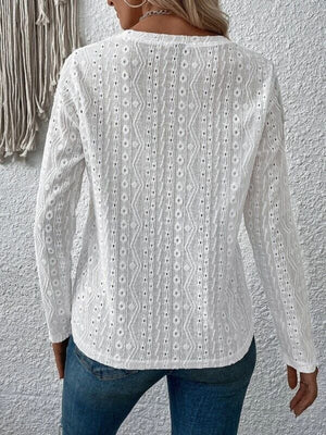 White eyelet long sleeve knit top with geometric pattern detail.