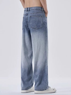 Relaxed fit men's sweatpants in light blue with vintage wash and gradient effect.