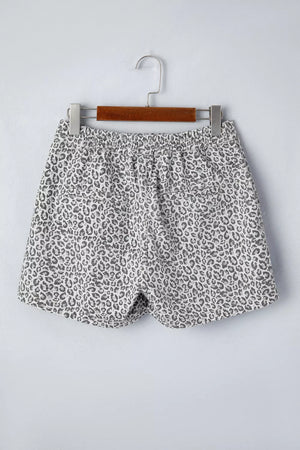 Denim shorts with leopard print, elastic waist, and pockets.