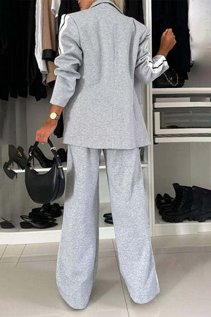 Light gray track stripe blazer and wide leg trouser set with black stripe detail on sleeves and pant legs.