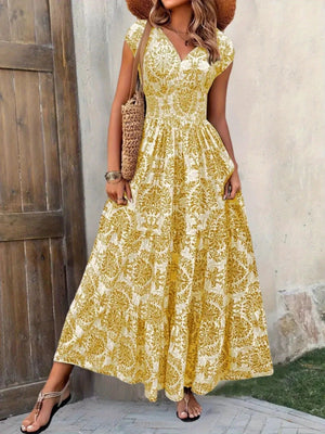 Yellow damask print maxi dress with cap sleeves and tiered skirt.