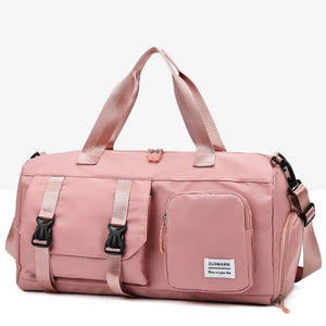 Dusty Pink gym duffel bag with buckle details and multiple pockets.