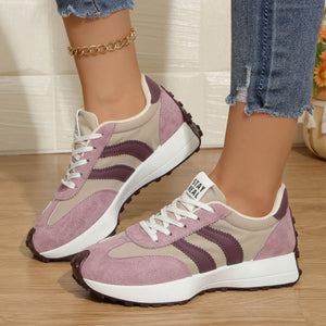 Lace up round toe sneakers in pink and tan with purple accents and a chunky sole.