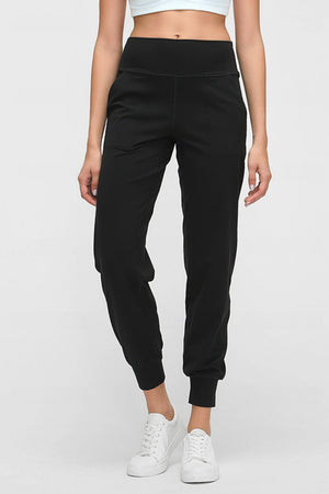 Black jogger fit performance trousers with pockets and cuffed ankles.
