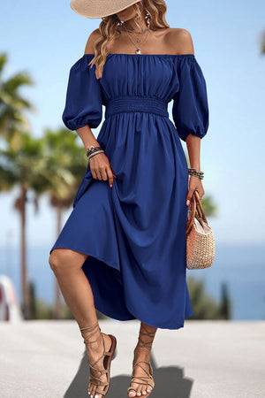 Off-shoulder puff sleeve empire midi dress in dark blue with smocked waist and A-line skirt.