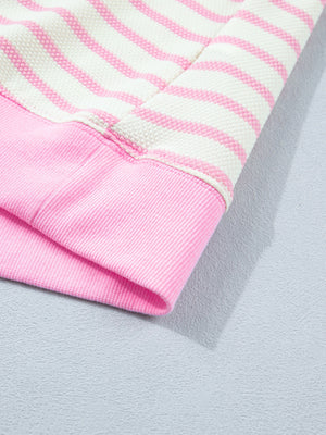 Ruffled short-sleeve blouse in pink and white stripes with a pink ribbed cuff detail.