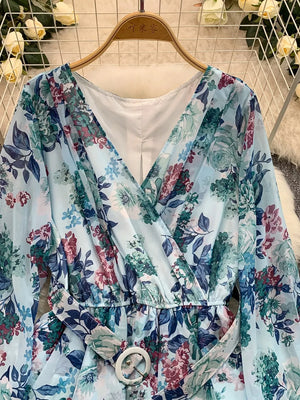 Light blue floral wrap mini dress with V-neck, cinched waist, and belt.