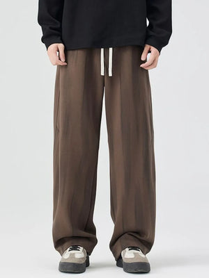 Brown jogger sweatpants with drawstring waist and relaxed fit.