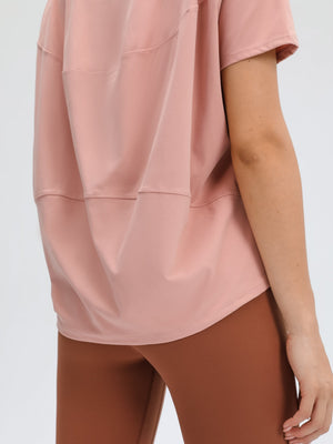 Relaxed fit tee in dusty rose with short sleeves and a curved hem.