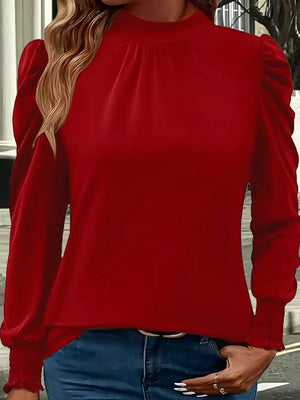 Red gathered mock neck maternity shirt with puff sleeves and ruffled cuffs.