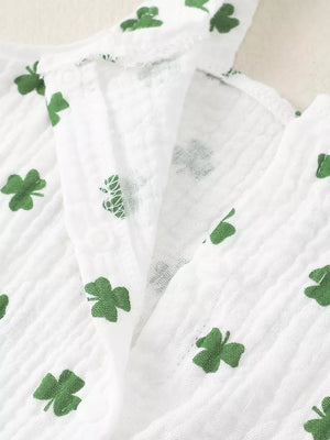 White cotton baby set with green shamrock print and ruffle detail.