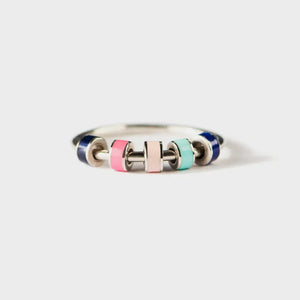 Sterling ring with colorful enamel beads in pink, light pink, teal, and navy.