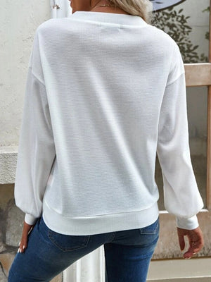 White waffle knit button-down cardigan with balloon sleeves and ribbed hem.
