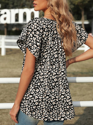 Leopard print V-neck blouse with short flutter sleeves.