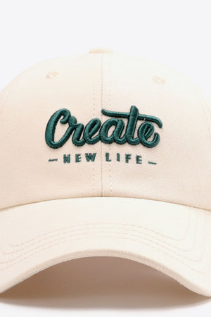 Ivory baseball cap with green embroidered "Create New Life" text.