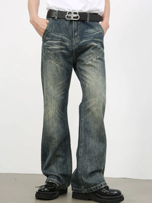 Vintage wash flare leg jeans in medium blue denim with distressed details and angled pockets.