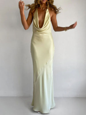 Yellow satin halter maxi dress with asymmetric detail and cowl neck.
