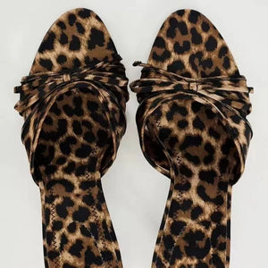Leopard print knot heel mules with a pointed toe and knotted strap detail.