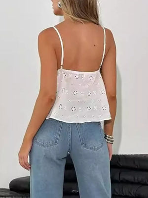 White eyelet lace cami with floral cutouts and adjustable straps.