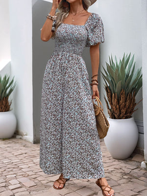 Floral smocked bodice wide leg jumpsuit in dusty pink with puff sleeves and square neckline.