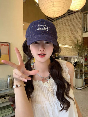 Navy blue cotton baseball cap with embroidered floral pattern and script logo