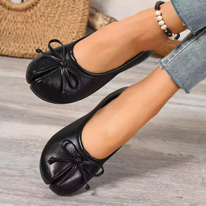 Black tabi slip-on flats with bow detail and split toe.