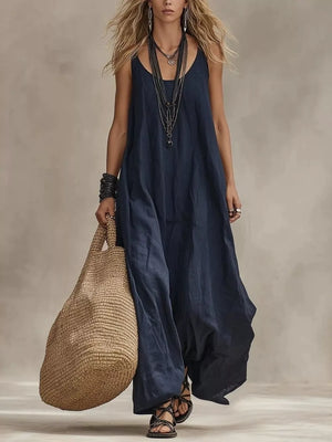 Dark blue scoop neck maxi dress with spaghetti straps and flowing skirt.