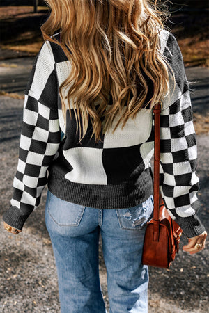 Colorblock checkerboard knit sweater in black and white acrylic with crew neck.