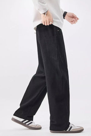 Men's black relaxed fit cotton jeans with drawstring waist and back pockets.