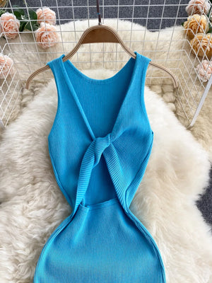 Light blue ribbed knit midi dress with a knot-back detail and cutout.