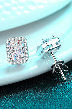 Silver halo stud earrings with radiant emerald cut center stone