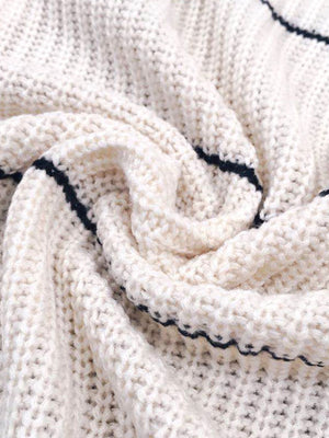 White open knit cardigan with horizontal navy stripes and a textured acrylic weave.