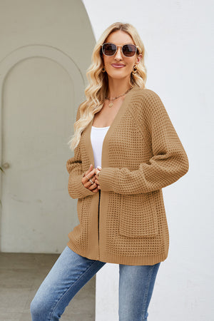 Caramel waffle knit raglan pocket cardigan with open front and long sleeves.