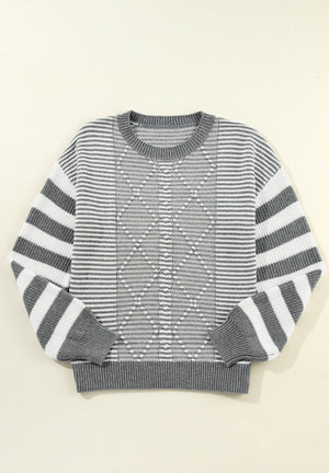 Gray and white striped knit sweater with diamond pattern detail.