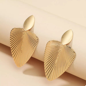 Gold dangle earrings with a ribbed leaf silhouette design.
