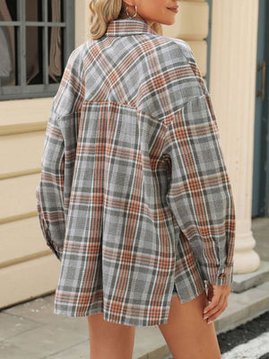 Gray plaid collared long sleeve shirt with button cuffs and a back yoke detail.