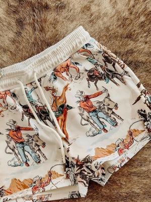 White drawstring shorts with a vintage rodeo print and elastic waistband.