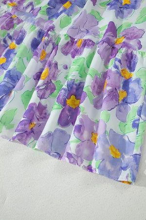 Vibrant floral mini dress with tiered ruffles and purple watercolor flowers.