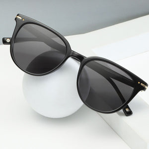 Black cat-eye sunglasses with polycarbonate frame and gold accents