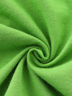 Green cotton fabric detail of baby tee and shorts set.