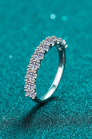 Silver eternity band ring with a row of brilliant moissanite stones.